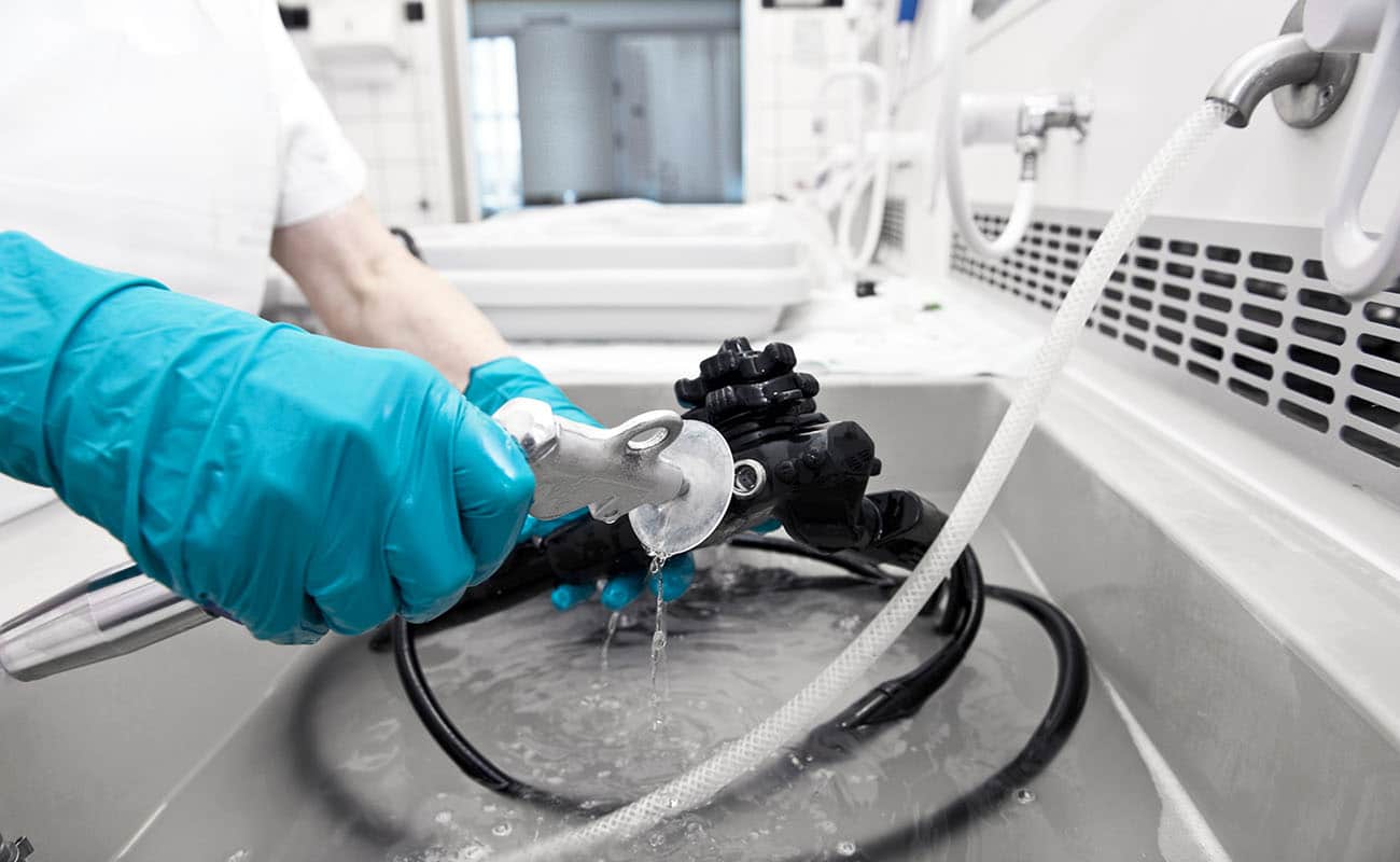 hand with glove is cleaning hospital equipment