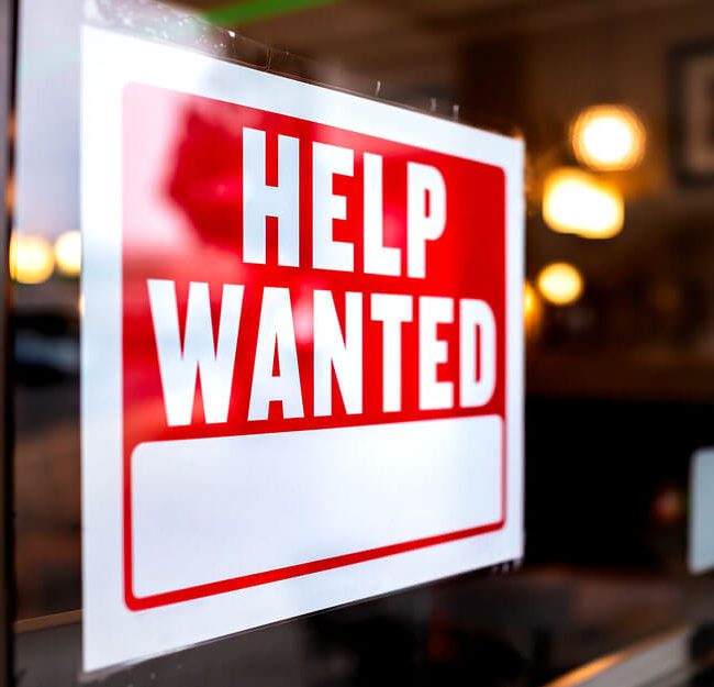 Help wanted sign on front of business window